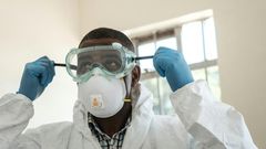 Virus threat: A lab technician gears up for visiting a quarantine ward at the Kenyatta National Hospital in Nairobi
