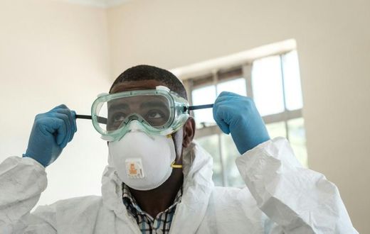 Virus threat: A lab technician gears up for visiting a quarantine ward at the Kenyatta National Hospital in Nairobi