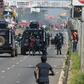 Police officers arrest a man during a protest against the third term of the Guinean President in Conakry, on November 14, 2019