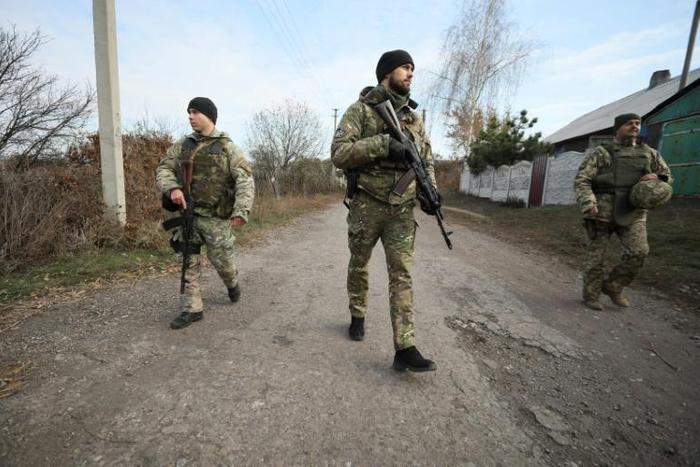 Ukrainian servicemen patrol in the streets of the village of Katerynivka, in the Lugansk region. The conflict in eastern Ukraine has been raging since 2014