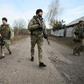 Ukrainian servicemen patrol in the streets of the village of Katerynivka, in the Lugansk region. The conflict in eastern Ukraine has been raging since 2014