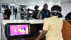 A thermal scanner screens passengers at Lagos international airport