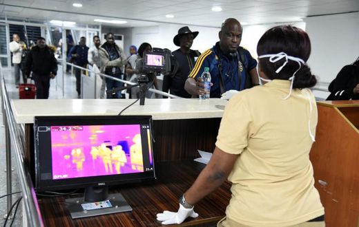 A thermal scanner screens passengers at Lagos international airport