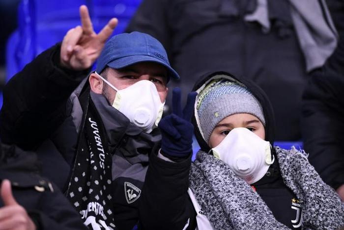 Juventus supporters wear protective face masks as a safety measure against the COVID-19