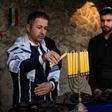 Members of the Jewish community in Iraqi Kurdistan light a menorah for Hanukkah in the town of Al-Qosh