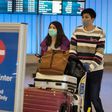 Passengers wearing protective masks arriving at Los Angeles International Airport in California