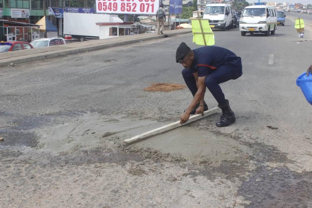 Police officer Lance corporal Simon Agbeko fills deadly potholes in Accra to save lives