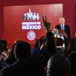 A reporter raises his hand to ask a question during Mexican President Andres Manuel Lopez Obrador's daily morning press conference at the National Palace in Mexico City on November 21, 2019