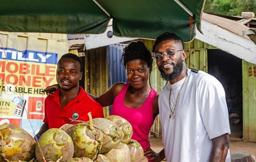 ‘God bless your hustle’ – Adebayor inspires couple selling coconut on the street
