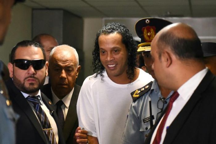 Retired Brazilian football player Ronaldinho (C) arrives at the Justice Palace in Asuncion on March 6, 2020 
to testify about his irregular entry to the country