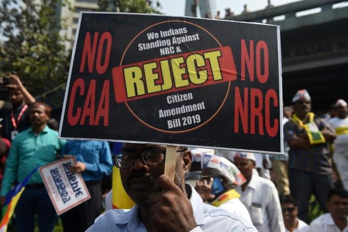 A protester holds a placard during a demonstration against India's new citizenship law in Mumbai
