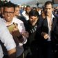 Venezuela's self-proclaimed acting president Juan Guaido (C) is seen being escorted to his car on February 11, 2020, upon arrival at the international airport near Caracas, after a foreign tour; authorities detained his uncle