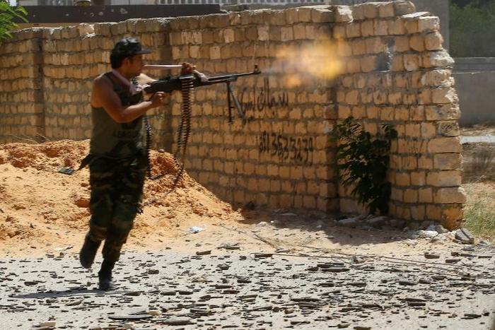 A fighter loyal to Libya's internationally recognized government fires during clashes with forces loyal to strongman Khalifa Haftar in Tripoli