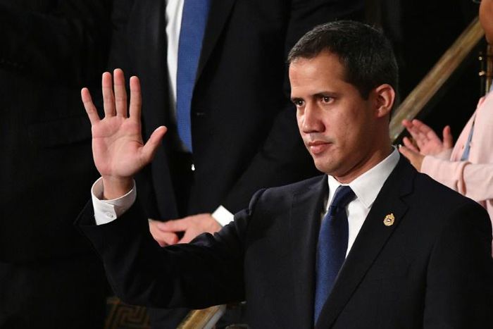 Venezuelan opposition leader Juan Guaido waves as he is acknowledged by US President Donald Trump during the State of the Union address