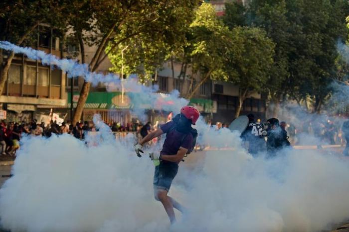 Chilean demonstrators clash with security forces during a protest against the government in Santiago on November 29, 2019: the Inter-American Commission on Human Rights has called on Chile to end the use  of "excessive force"