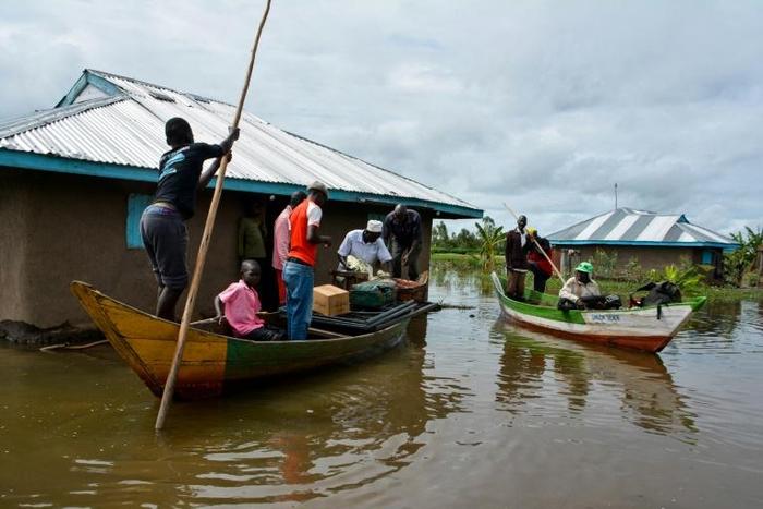 Rescue boats evacuate families after their houses were flooded in Kenya
