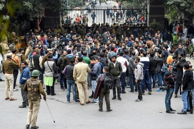 Students and their supporters face off against police outside the Jawaharlal Nehru University gate in New Delhi