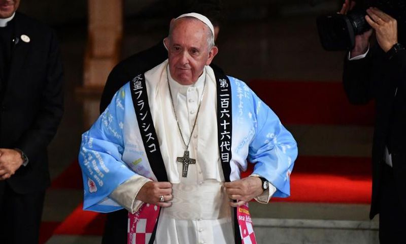 Pope Francis tries on a Japanese souvenir shirt