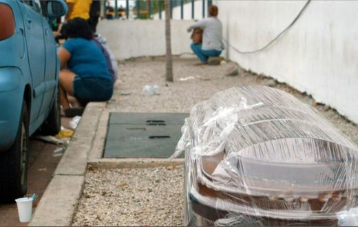 A coffin wrapped in plastic is seen outside a hospital in Guayaquil on April 1