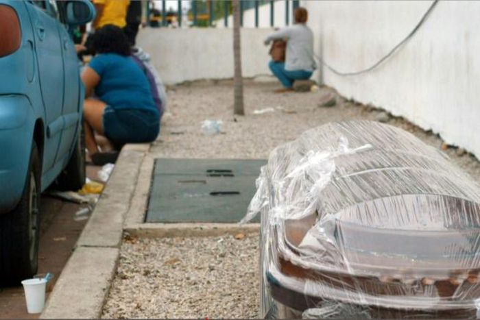 A coffin wrapped in plastic is seen outside a hospital in Guayaquil on April 1