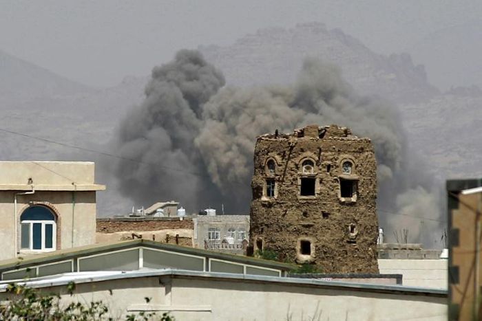 Smoke billows from buildings after reported air strikes in 2025 by the Saudi-led coalition on arms warehouses at an airbase controlled by Huthi rebels