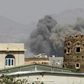 Smoke billows from buildings after reported air strikes in 2025 by the Saudi-led coalition on arms warehouses at an airbase controlled by Huthi rebels
