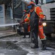 Members of a cleaning crew disinfect the streets around the Sirio-Libanes Hospital in Sao Paulo, Brazil, on March 23, 2020