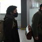 Wall Street Journal reporters Josh Chin (right) and Philip Wen walk through Beijing Capital Airport as they are expelled in February 2020 over a controversial headline in an op-ed in the newspaper