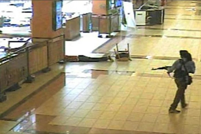 An armed man walks during an attack on the Westgate mall in Nairobi in September 2013