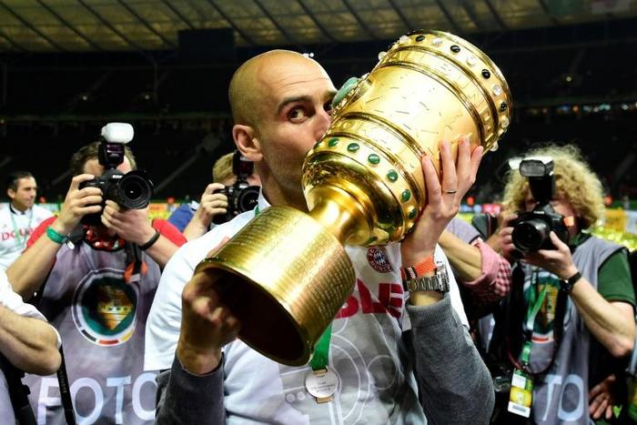 Pep Guardiola kisses the German Cup in May 2016, after Bayern Munich beat Borussia Dortmund in the final at Berlin's Olympic Stadium, just before he left to coach Manchester City