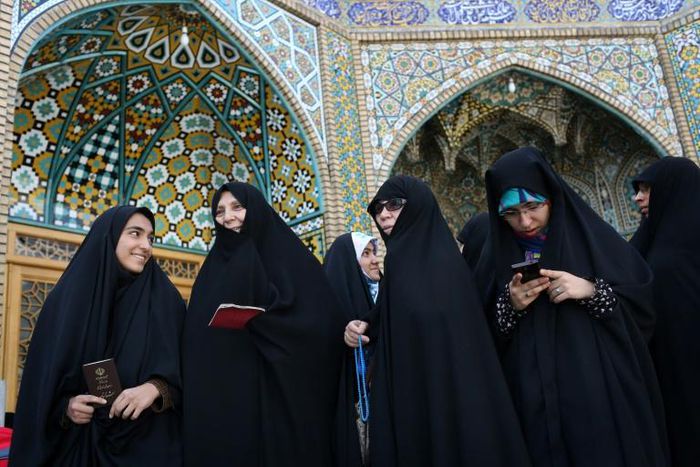 Iranian women queue to vote in the 2017 presidential election in the Shiite holy city of Qom