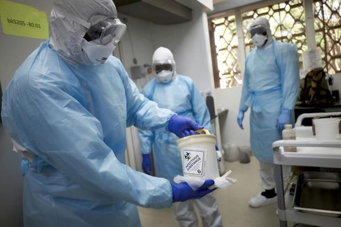 Mali, mired in an eight-year-old conflict, said two nationals who had returned from France tested positive for the virus. Here, a Malian researcher holds a sample to be tested at a research center in Bamako