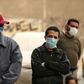 Egyptian men wait outside a food bank, after movement restrictions imposed to fight coronavirus crippled already precarious livelihoods