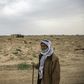 Farmer Hamad al-Ibrahim stands in his damaged fields in the eastern Syrian village of Baghouz
