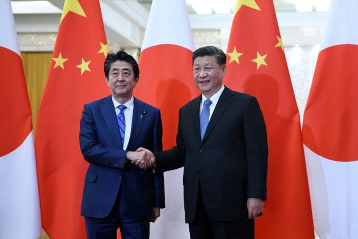 Japan's Prime Minister Shinzo Abe (left) shakes hand with China's President Xi Jinping at the Great Hall of the People in Beijing in December 2019
