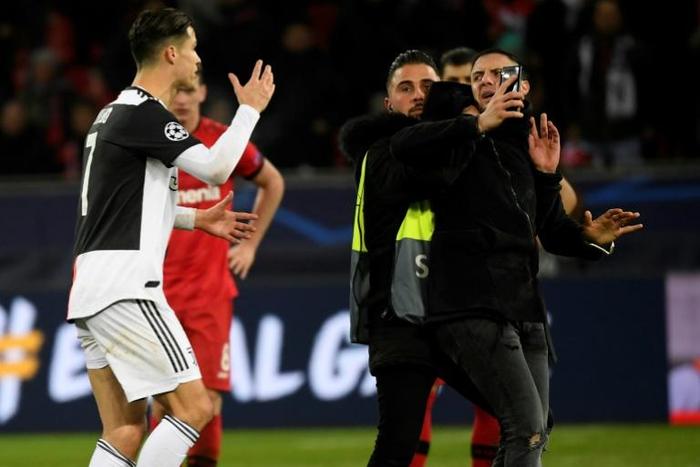 Close call: Cristiano Ronaldo berates a pitch invader who wanted a selfie with the Juventus star