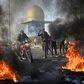 Iraqi protesters block the airport highway in the Shiite shrine city of Najaf, a major draw for foreign pilgrims
