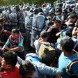 Members of the Mexican National Guard scuffle with Central American migrants - mostly Hondurans heading in a caravan to the US - in Ciudad Hidalgo, Chiapas State on Thursday
