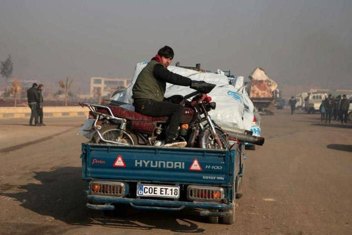 Syrians carrying their belongings have been fleeing the southern Idlib region toward the north amid heavy bombardment