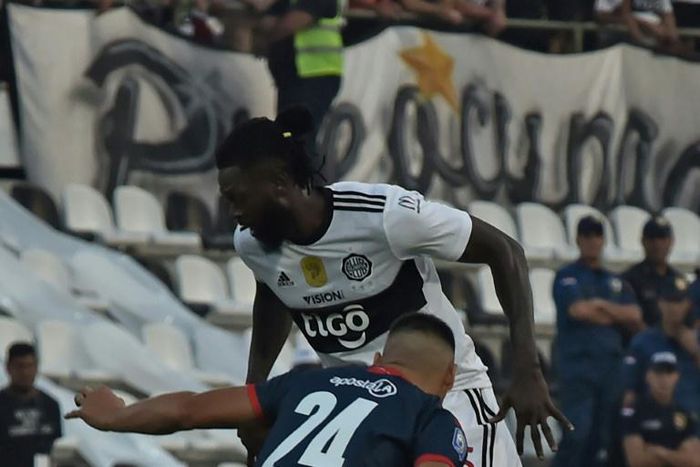 Adebayor (top) made his Olimpia debut on Sunday