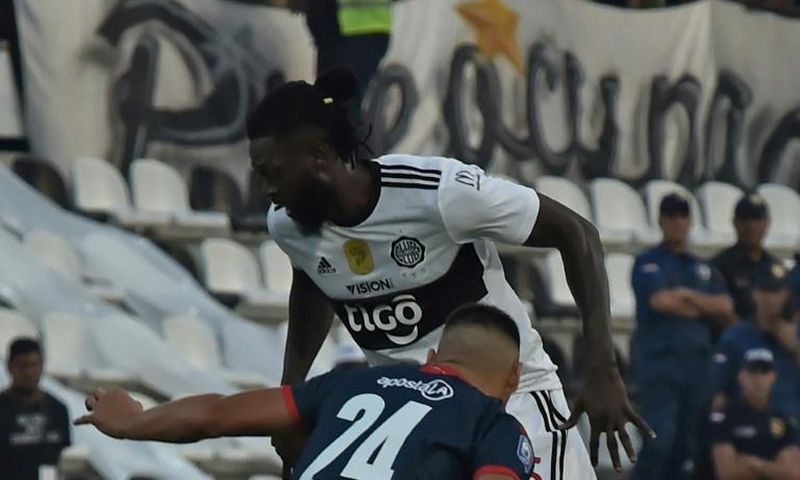 Adebayor (top) made his Olimpia debut on Sunday