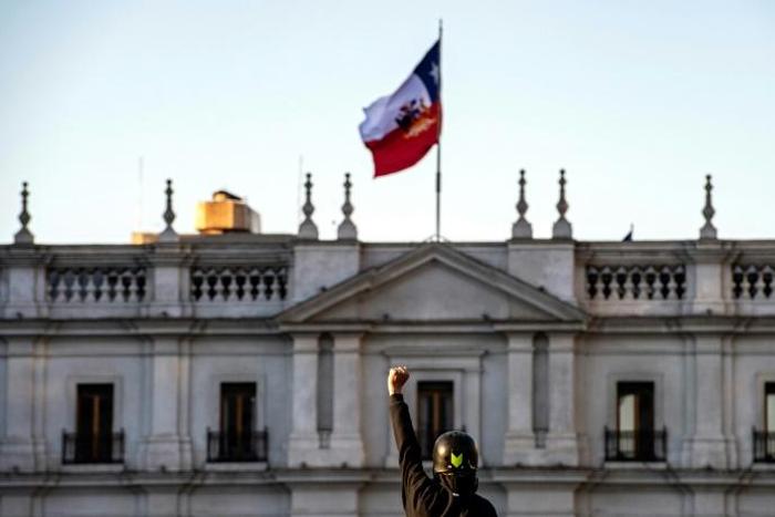A demonstrator in front of the presidential palace during a protest against Chilean President Sebastian Pinera's government on December 20, 2019