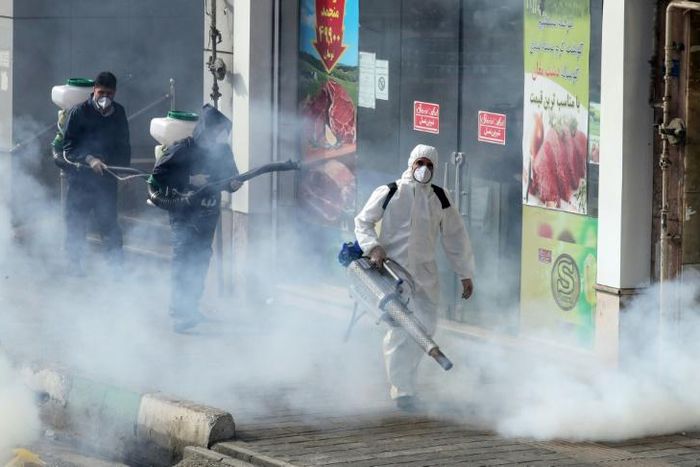 Iranian firefighters and municipality workers disinfect streets in the capital Tehran in a bid to halt the wild spread of coronavirus