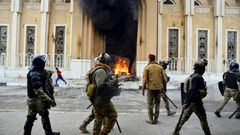 Smoke billows from a shrine in the Shiite holy city of Najaf dedicated to the late Ayatollah Mohammed Baqir al-Hakim, who founded one of Iraq's main Shiite political parties