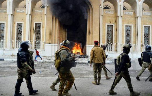 Smoke billows from a shrine in the Shiite holy city of Najaf dedicated to the late Ayatollah Mohammed Baqir al-Hakim, who founded one of Iraq's main Shiite political parties