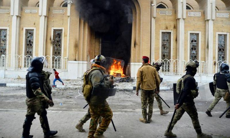 Smoke billows from a shrine in the Shiite holy city of Najaf dedicated to the late Ayatollah Mohammed Baqir al-Hakim, who founded one of Iraq's main Shiite political parties