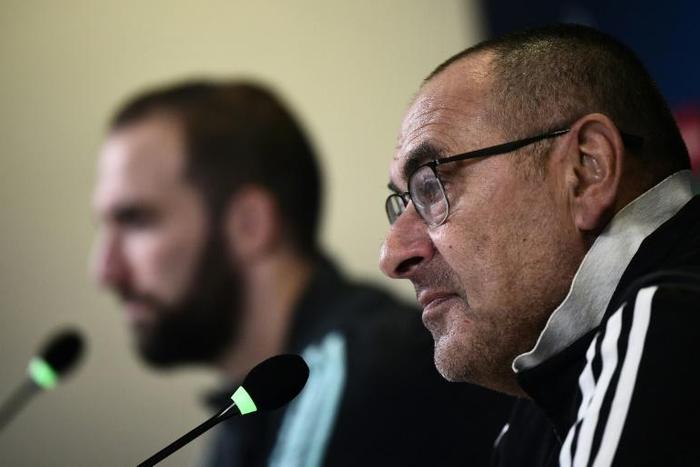 Juventus coach Maurizio Sarri (R) and forward Gonzalo Higuain speak during a press conference in Turin.