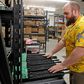 A worker moves finished AR-15 rifle barrels for storage at Delta Team Tactical in Orem, Utah