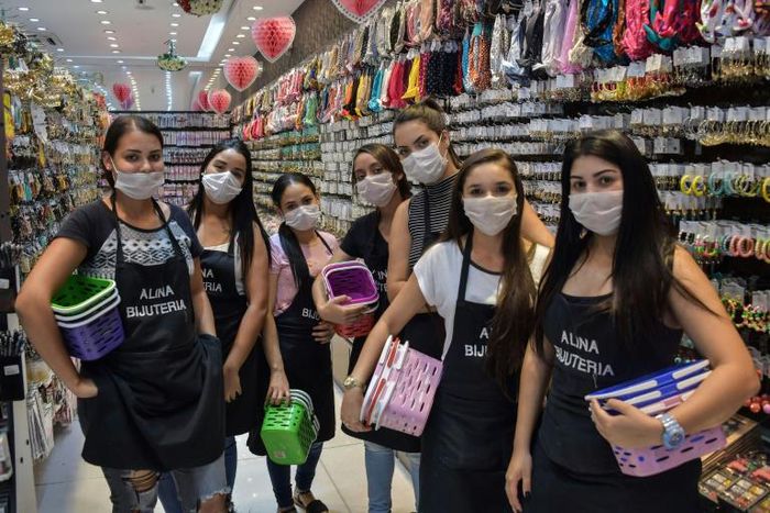 Shop-sellers wear face masks as a preventive measure against the spread of the new coronavirus in downtown Sao Paulo, Brazil
