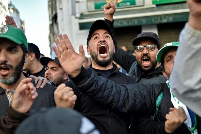 Anti-government protesters in Algiers yell slogans against next month's presidential election on November 29, 2019